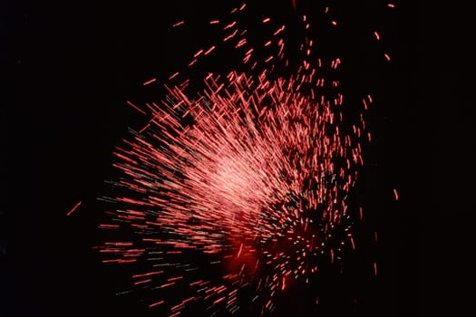 Burst of brilliant red sparkling fireworks