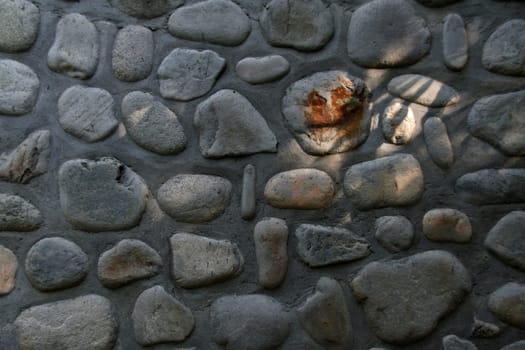 Wall decor with stone pebbles of various shapes and sizes