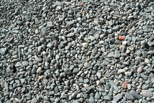 Bed of smooth-edged, rounded, gray stone pebbles