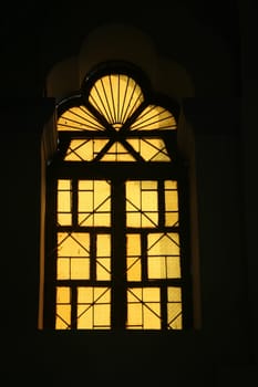 Light filtered through decorative yellow stained window panes