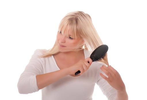 Young woman combing her hair
