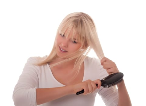 Young woman combing her hair