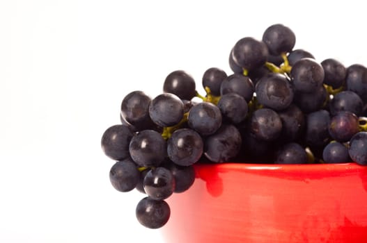 Red grapes in red porcelain bowl