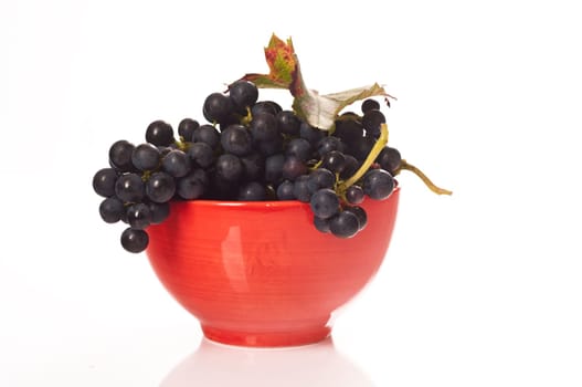 Red grapes in red porcelain bowl