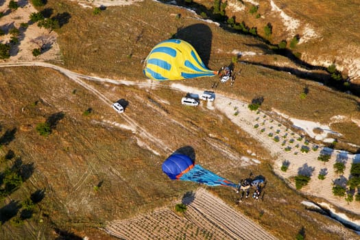 June 2011 aerial view of landed hot air balloons being packed away, Cappadocia, Turkey, Horizontal, copy space