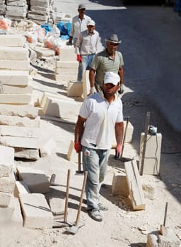 Goreme, Turkey - June, 2011: Four Turkish builders in line formation on a bright sunny day