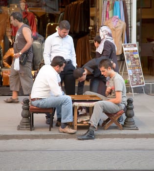 Istanbul, Turkey - June, 2011: pass time of backgammon on streets of Istanbul with spectators