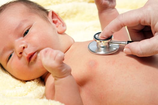 Stethoscope listening to a baby&#039 s heart beat