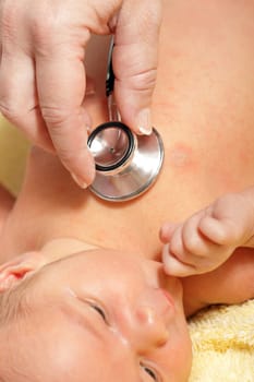 Stethoscope listening to a baby&#039 s heart beat