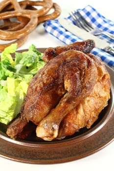 a roast chicken with salad on a plate