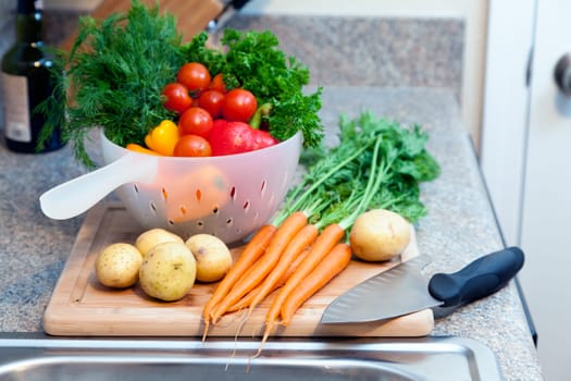 Freshly washed vegetables and herbs on a cutting board