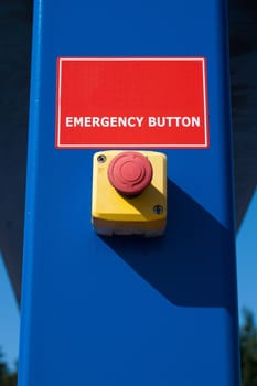red emergency button on blue culomn