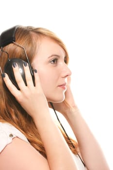 Young redhead woman with headphones listening to music against white background