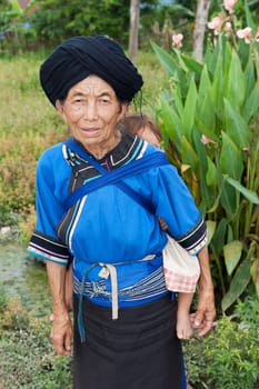 Grandmother with grandson,asian ethnic group Lolo in traditional costume