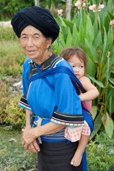 Grandmother with grandson,asian ethnic group Lolo in traditional costume