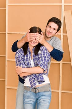 New home improvement young couple man cover eyes happy woman