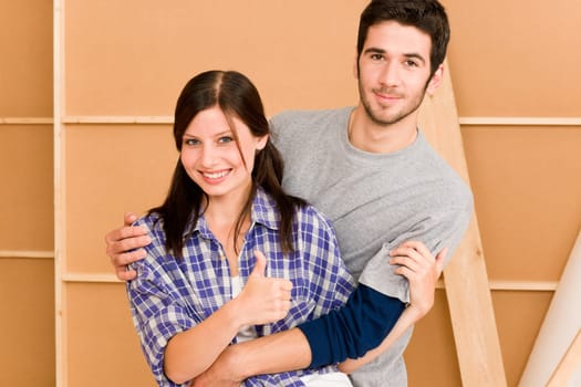 Home improvement young couple posing together in new house