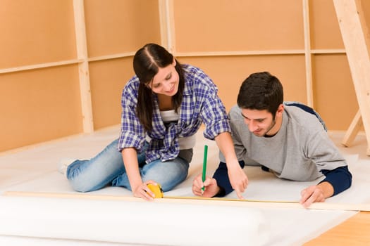 Home improvement young couple working on floor renovations