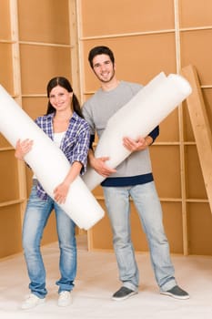 Home improvement young happy couple working on floor renovations