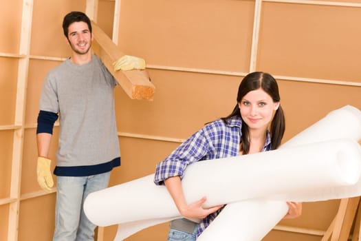 Home improvement young happy couple working on floor renovations
