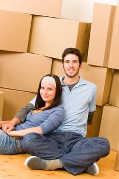 Moving into new home young happy couple sitting on floor