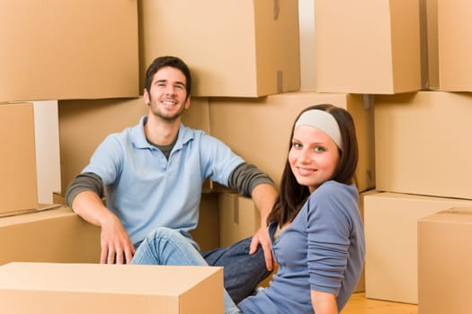 Moving into new home young happy couple sitting on floor