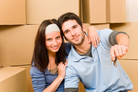 Moving into new home young happy couple holding house keys