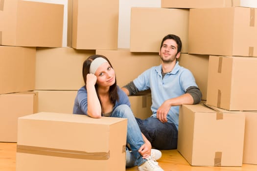 Moving into new home young happy couple sitting on floor