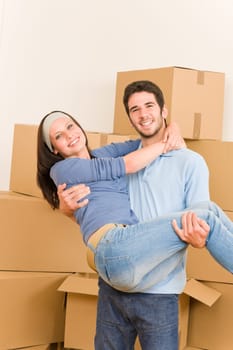 Moving new home young happy man holding woman cardboard boxes