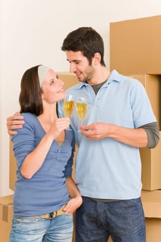Moving into new home young happy couple celebrating toast Champagne