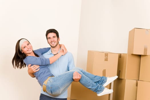 Moving new home young happy man holding woman cardboard boxes