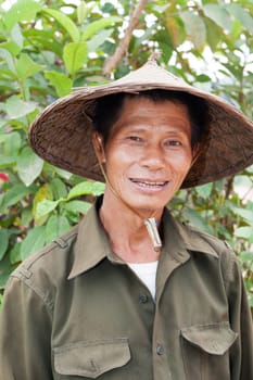 Portrait of friendly Asian,with traditional hat from Vietnam