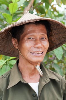 Portrait of friendly Asian,with traditional hat from Vietnam
