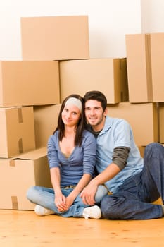 Moving into new home young happy couple sitting on floor