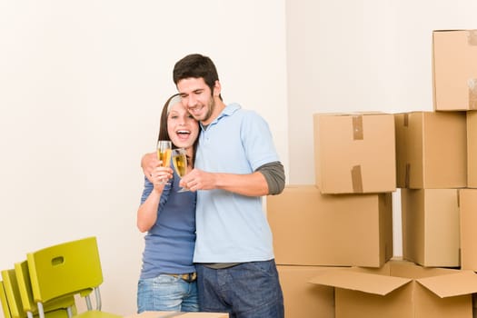 Moving into new home young happy couple celebrating toast Champagne
