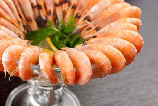 tasty shrimps with lemon and greens closeup