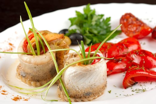 fillet of pikeperch stuffed with trout fish with baked pepper, tomato and leek