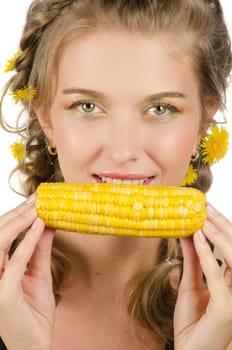 Close-up portrait of young beauty woman eating corn-cob on a white