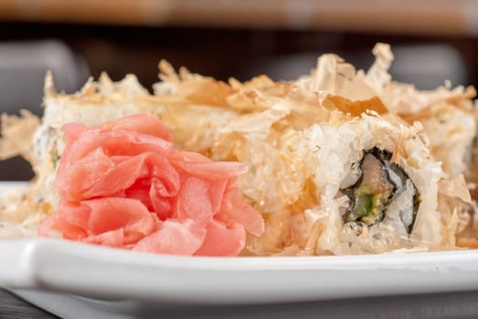 Sushi rolls of rice, nori, cream cheese, avocado, smoked salmon,cucumber and cuts of tuna