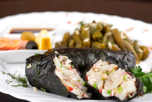 souffle of fillet of pikeperch, shrimps, crab meat, coconut and leek wrapped at nori garnished by string beans