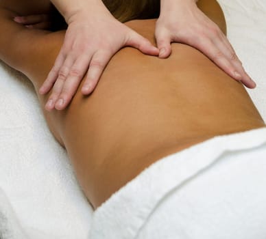 closeup of young woman getting a back massage
