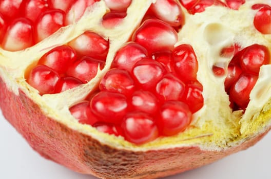 Half of pomegranate closeup on a white background
