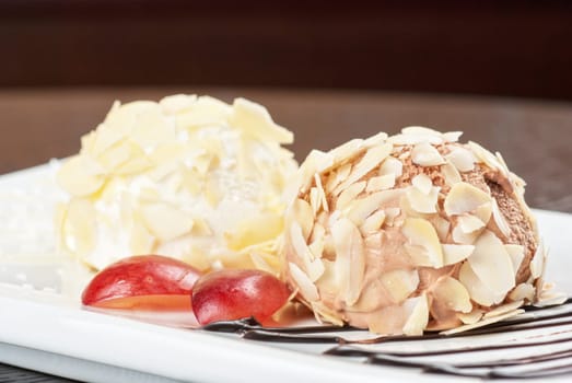 Dessert set of ice-cream with almond, chocolate and grapes