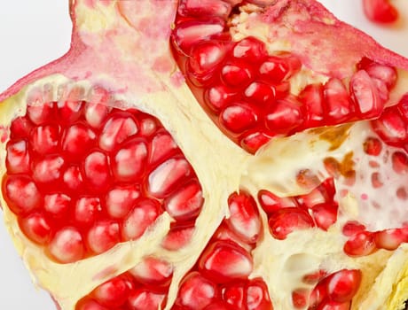 Half of pomegranate closeup on a white background