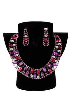 a necklace with pendants and earrings on a white background