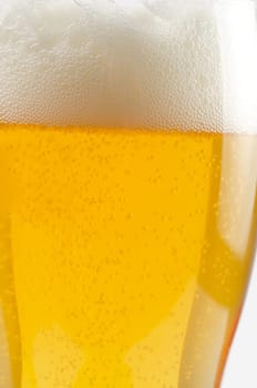 Glass of beer closeup on a white background