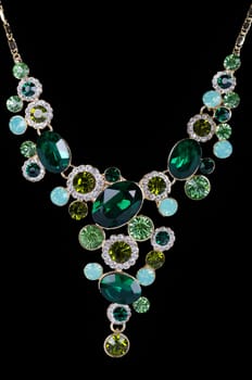 a necklace with pendants and earrings on a white background