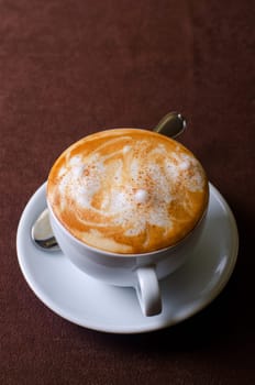 Cappuccino coffee cup closeup at the table