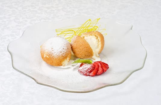 Dessert of ice-cream at biscuit with strawberry and caramel