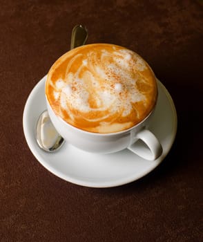 Cappuccino coffee cup closeup at the table